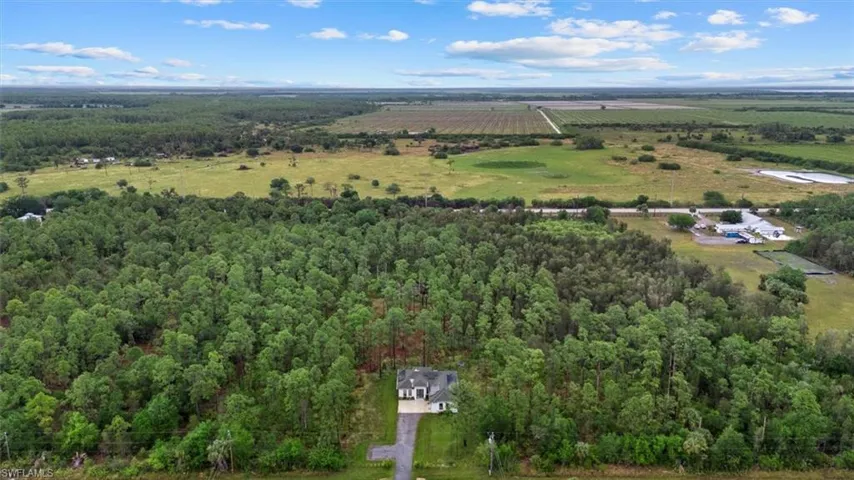 Birds eye view of property with a rural view and a forest view