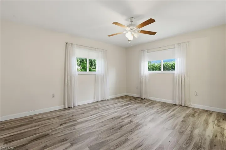 Comfortable primary suite with updated flooring, generous closet space, and natural light.