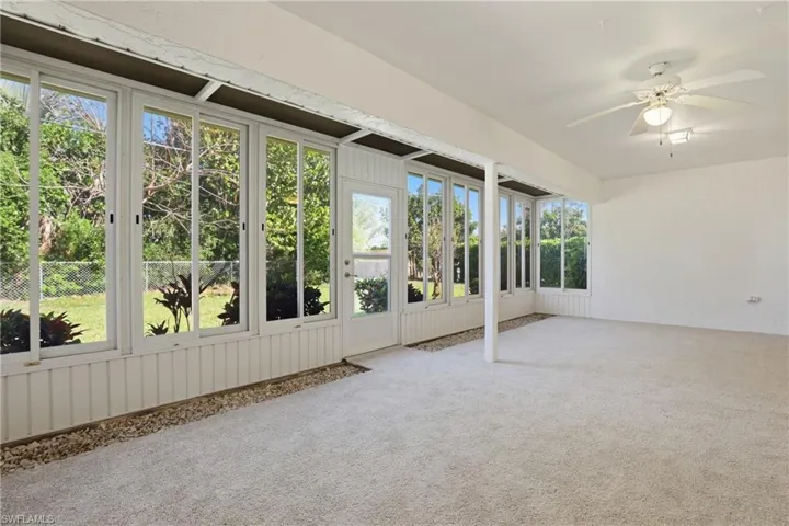 Huge covered and screened lanai with newer windows, offering year-round enjoyment and seamless indoor-outdoor living.