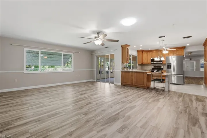 Airy family room with a skylight and sliding glass doors leading to the oversized screened lanai—ideal for relaxing Florida living.
