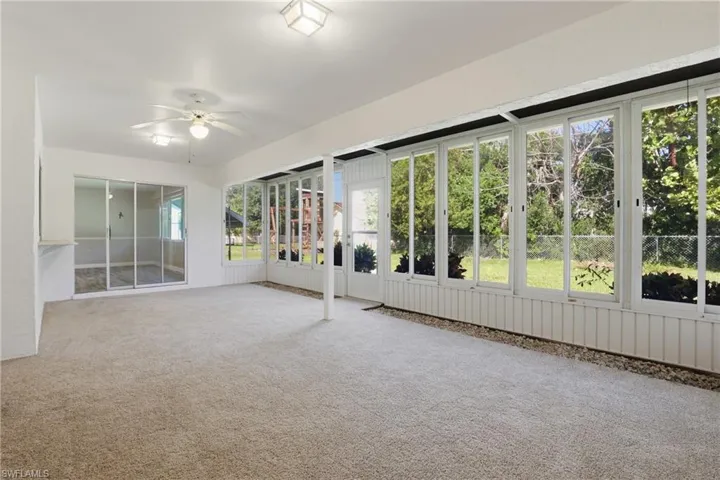 Huge covered and screened lanai with newer windows, offering year-round enjoyment and seamless indoor-outdoor living.