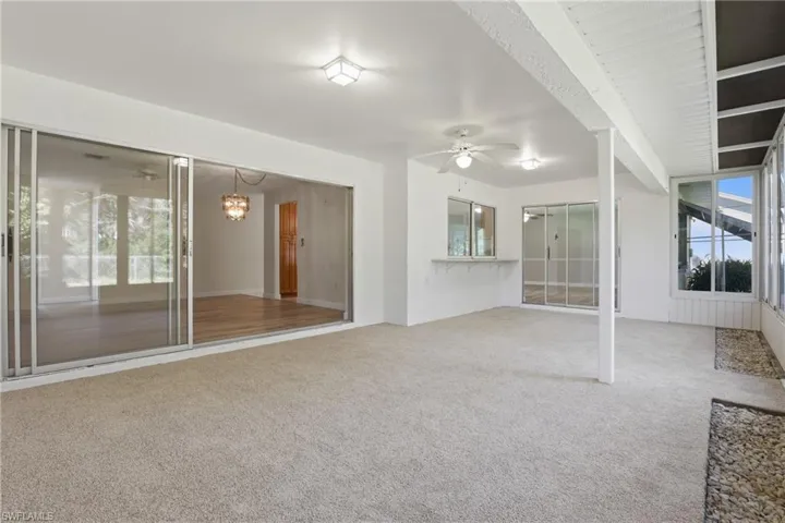 Huge covered and screened lanai with newer windows, offering year-round enjoyment and seamless indoor-outdoor living.