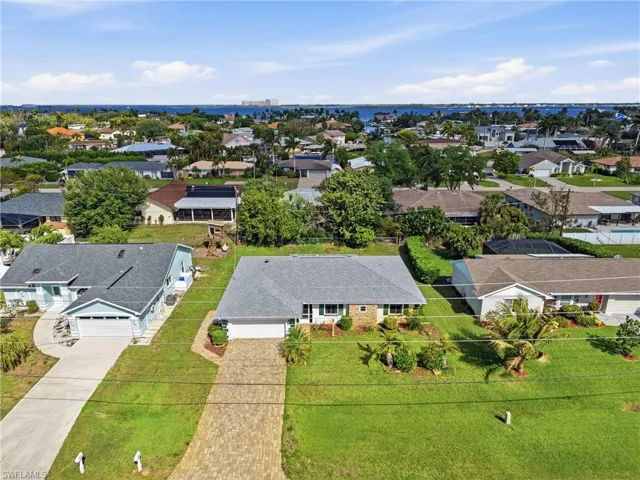 Bird’s-eye view of the peaceful Iona neighborhood, surrounded by lush greenery and well-kept homes, offering a quiet residential feel with quick access to shopping, dining, and island destinations.