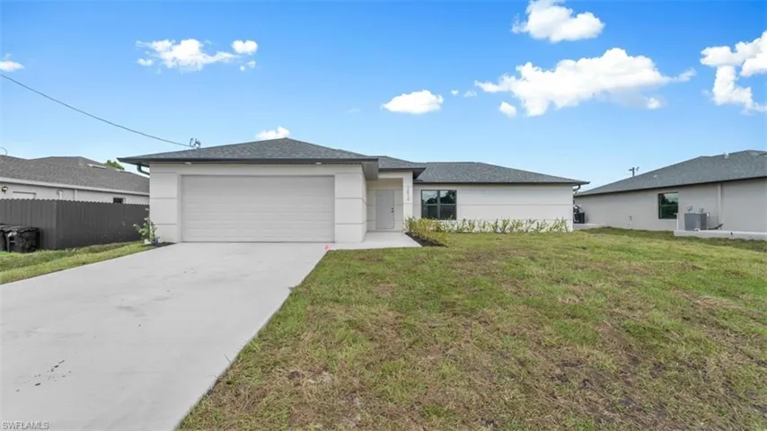 View of front of home with stucco siding, an attached garage, central AC unit, fence, and a front lawn