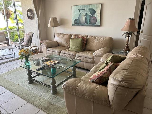 Living room with sliders out to Lanai and outstanding view to lake.