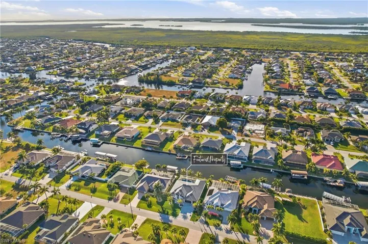 Aerial view of property's location featuring a large body of water and nearby suburban area