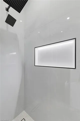 Full bath featuring a tile shower