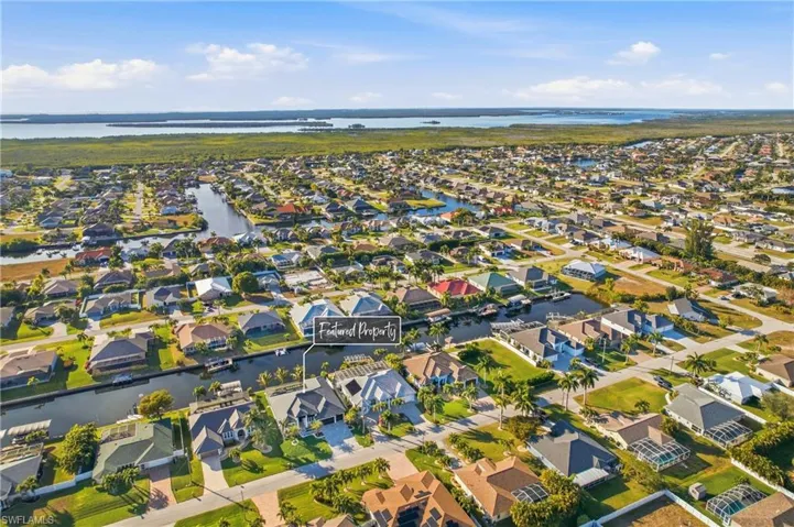 Aerial view of property's location with nearby suburban area and a large body of water