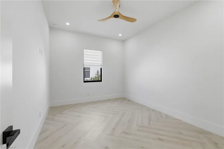 Unfurnished room featuring parquet floors, recessed lighting, and a ceiling fan