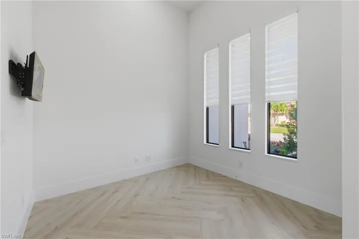 Spare room with parquet floors and baseboards