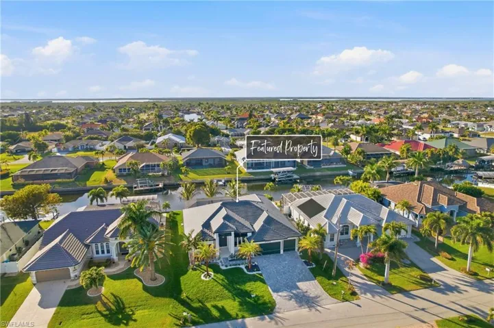 Aerial perspective of suburban area featuring a large body of water