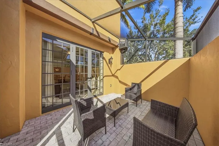 View of patio featuring a sunroom, a lanai, an outdoor lounge area, and french doors
