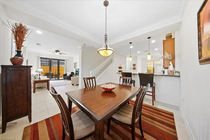 Dining room featuring ornamental molding, light tile patterned floors, a ceiling fan, and recessed lighting