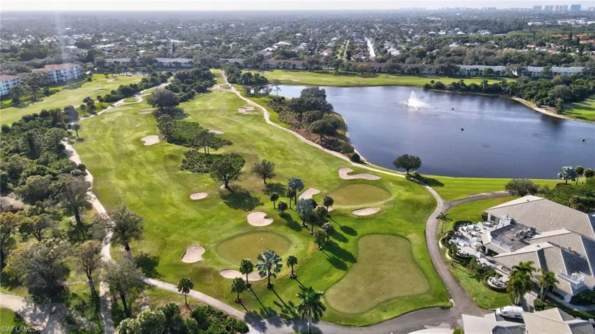Expansive golf course featuring manicured greens and multiple sand traps