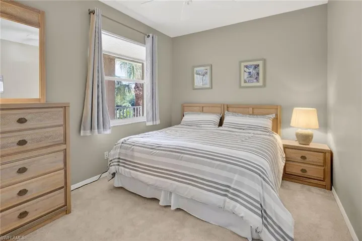 Carpeted room featuring neutral wall tones, a double-paned window, and a ceiling fan