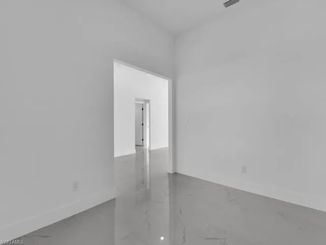 Unfurnished room with baseboards