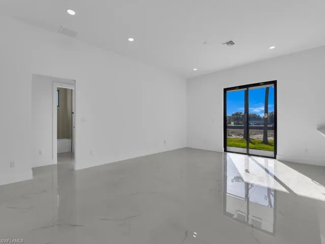 Unfurnished room with recessed lighting and light marble finish floors