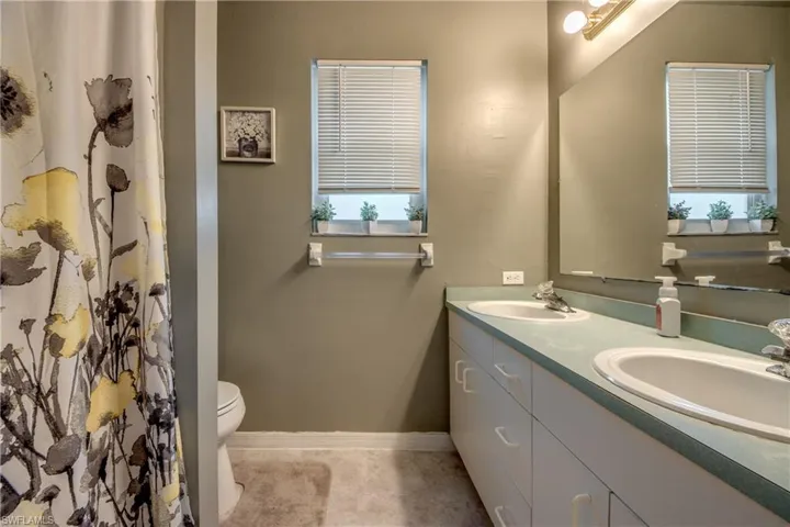 Bathroom with double vanity and toilet