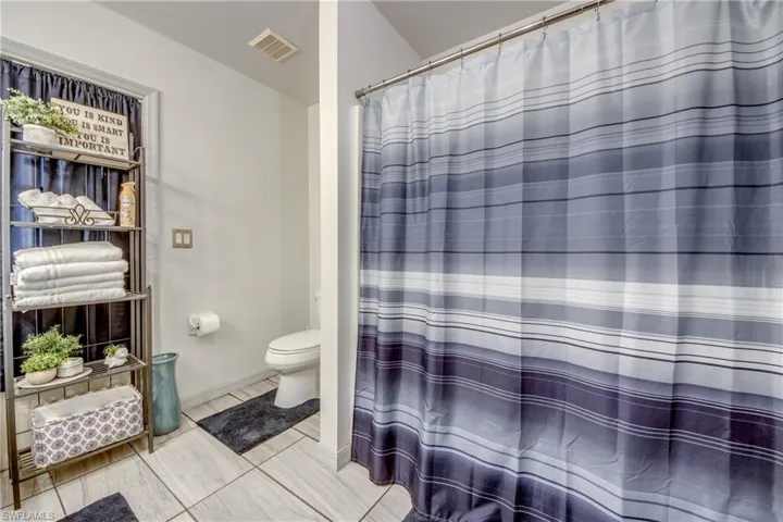 Bathroom with toilet and tile floors