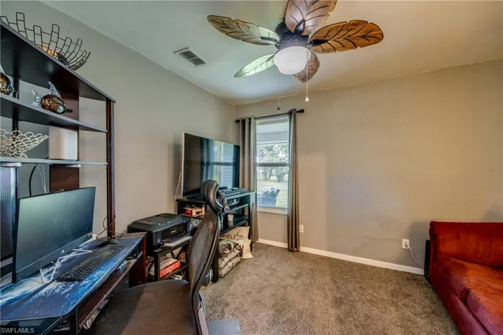 Carpeted office with ceiling fan