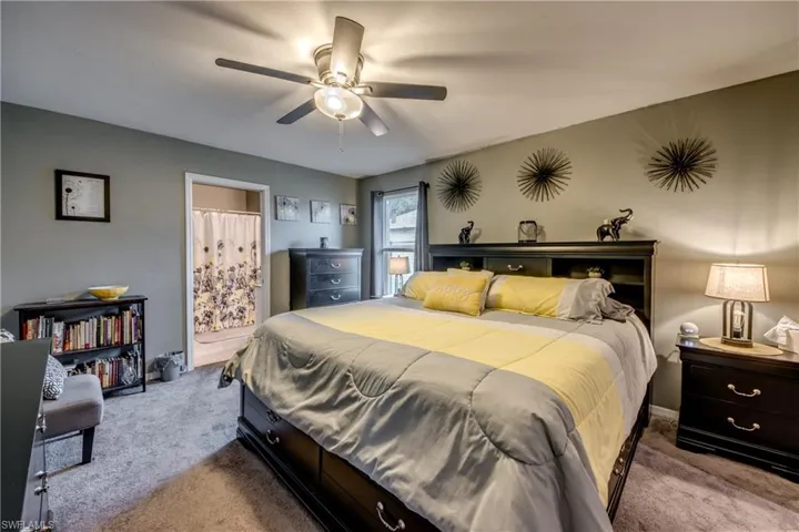 Carpeted bedroom with ceiling fan