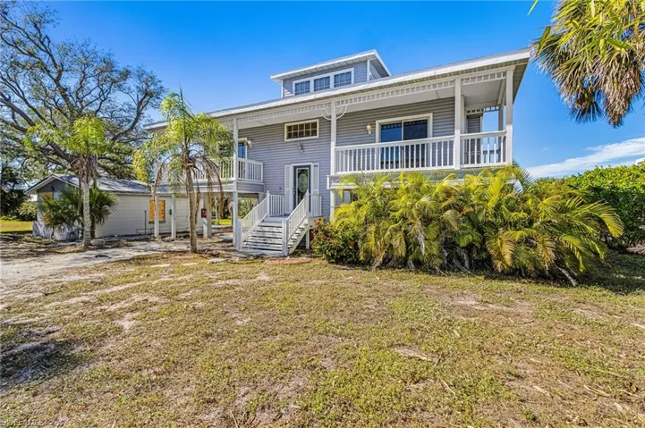 View of front of house featuring covered porch and a front lawn