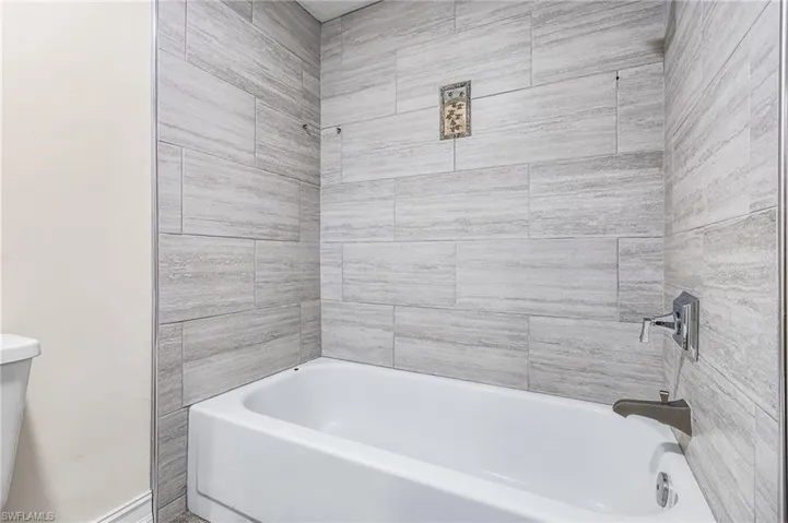 Bathroom with toilet and shower / bath combination