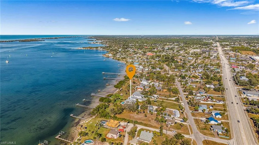 Aerial perspective of suburban area featuring a large body of water