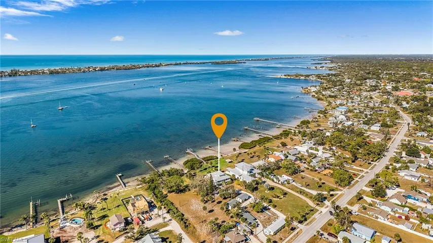 Aerial perspective of suburban area with a nearby body of water