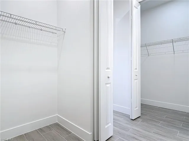 Walk in closet featuring wood tiled floor