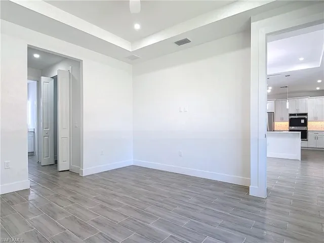 Spare room with recessed lighting, visible vents, and baseboards