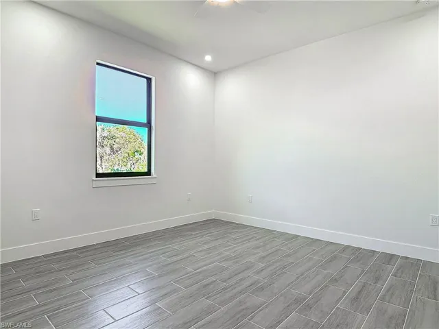 Spare room featuring recessed lighting, ceiling fan, baseboards, and wood finish floors