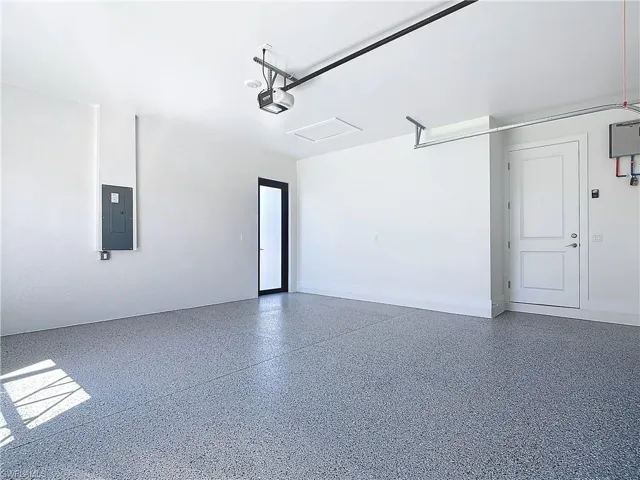 Garage with a garage door opener and electric panel