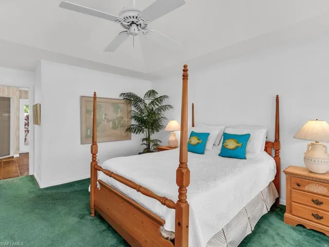 Carpeted bedroom with ceiling fan