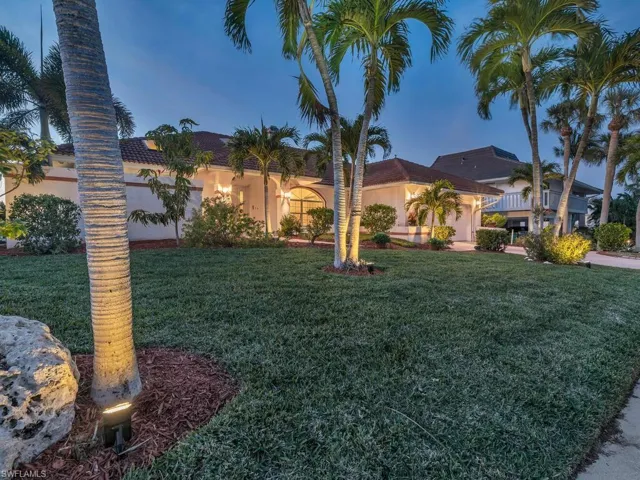 Home with a garage and a lawn