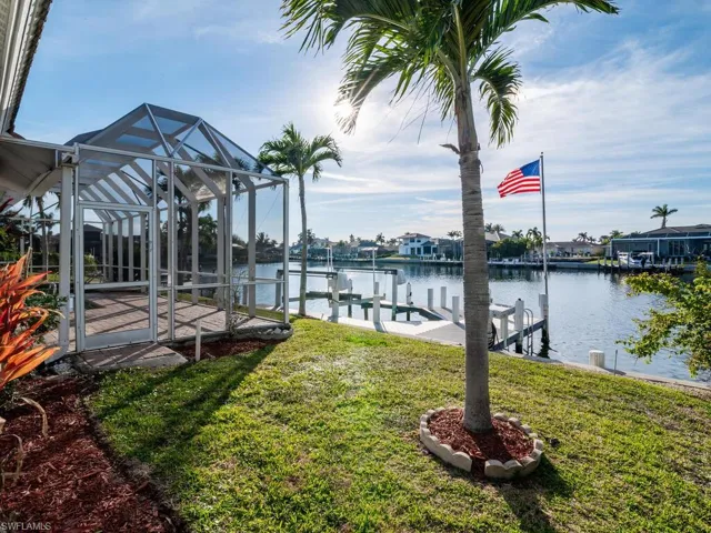 View of dock featuring a water view and a yard