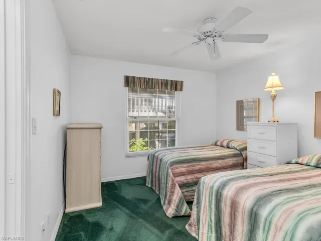 Carpeted bedroom with ceiling fan