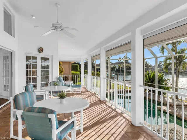 Sunroom featuring a water view, ceiling fan, and plenty of natural light