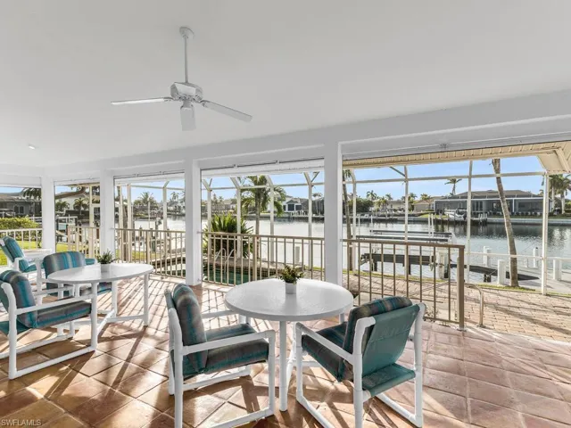 Sunroom with a water view and ceiling fan