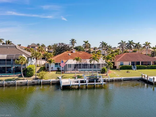 View of dock featuring a water view and a lawn