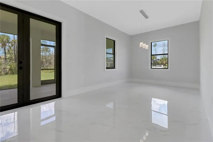 Unfurnished room with a chandelier