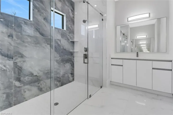 Bathroom with walk in shower and vanity