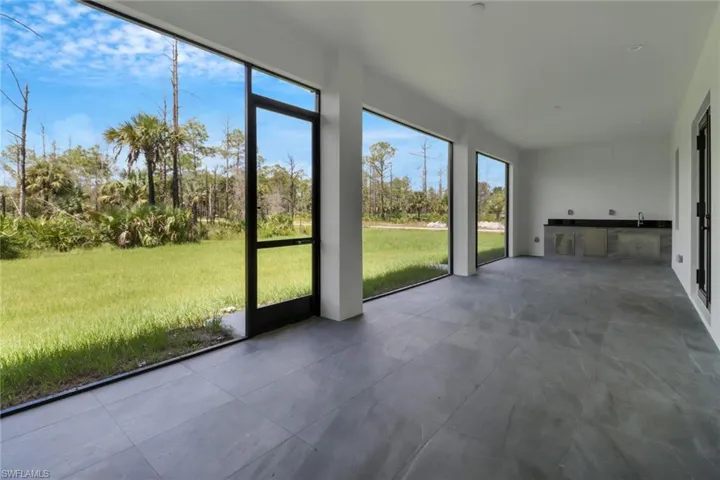 Unfurnished sunroom with sink