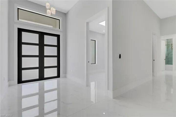 Foyer entrance with a healthy amount of sunlight and an inviting chandelier