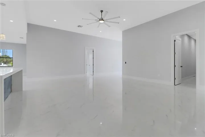 Unfurnished living room with ceiling fan