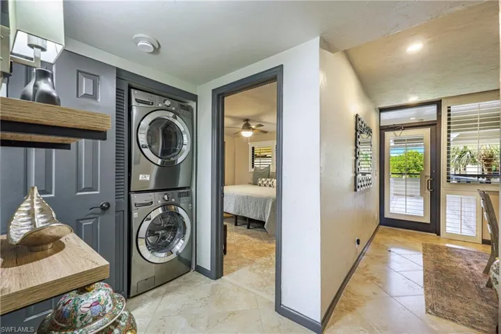 Well-designed interior laundry area with stacked washer and dryer for everyday convenience.
