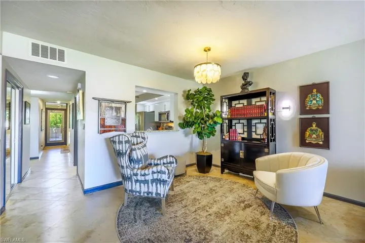 Entryway featuring light-toned tile flooring, recessed ceiling lighting, and a decorative pendant light fixture