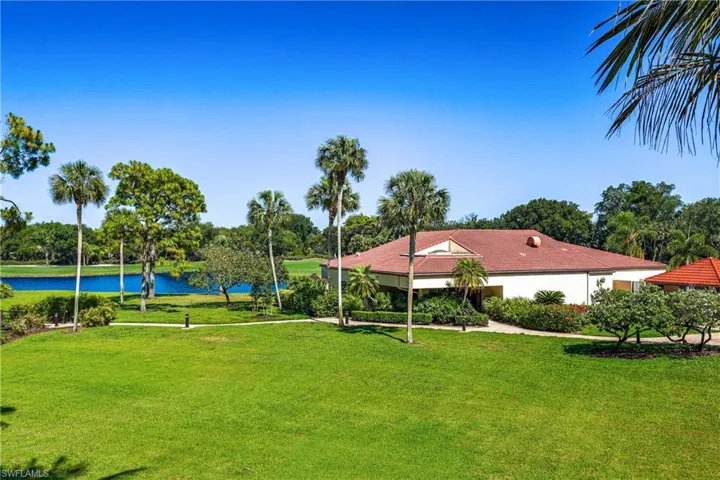 Peaceful green space overlooking the clubhouse and tropical surroundings, perfect for enjoying the outdoor Florida lifestyle.
