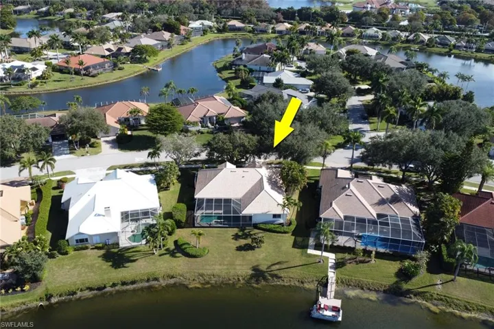 Aerial perspective of suburban area featuring a nearby body of water