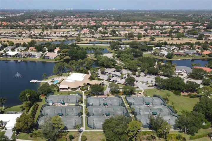 Aerial view of property's location featuring a nearby body of water and nearby suburban area
